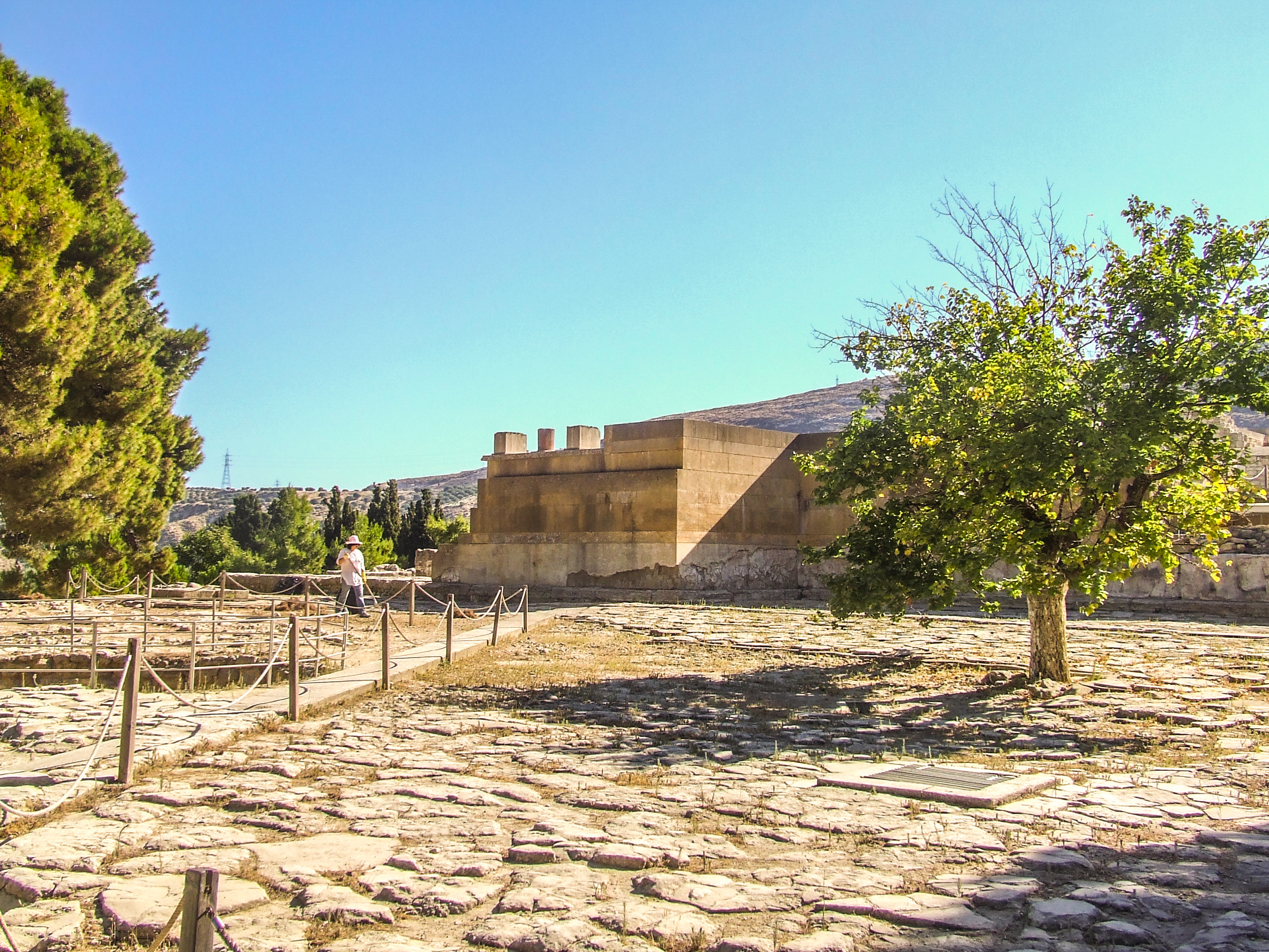 ancient ruin with a person walking along a roped path