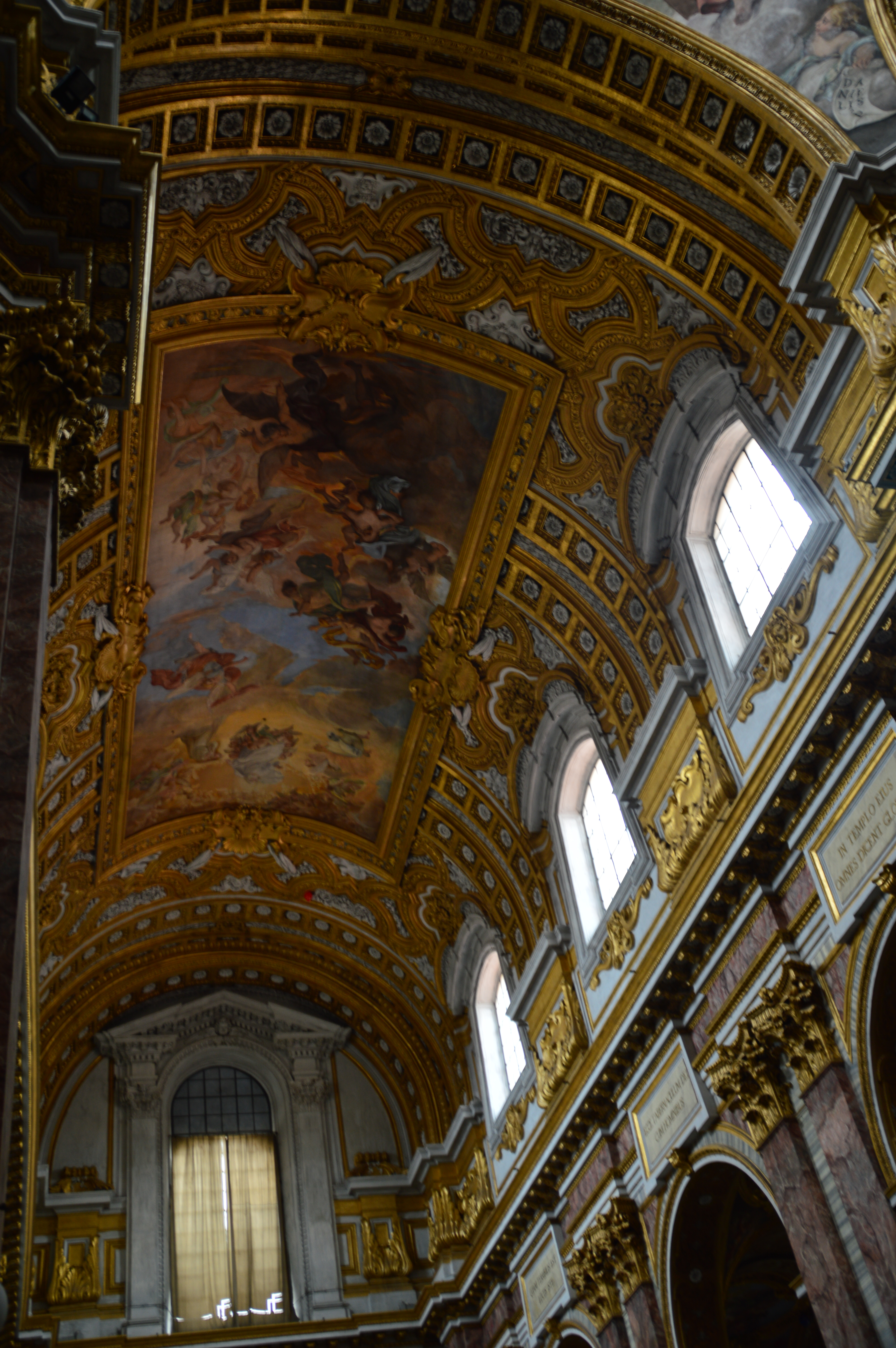 The ceiling is adorned with intricate frescoes and gold detailing