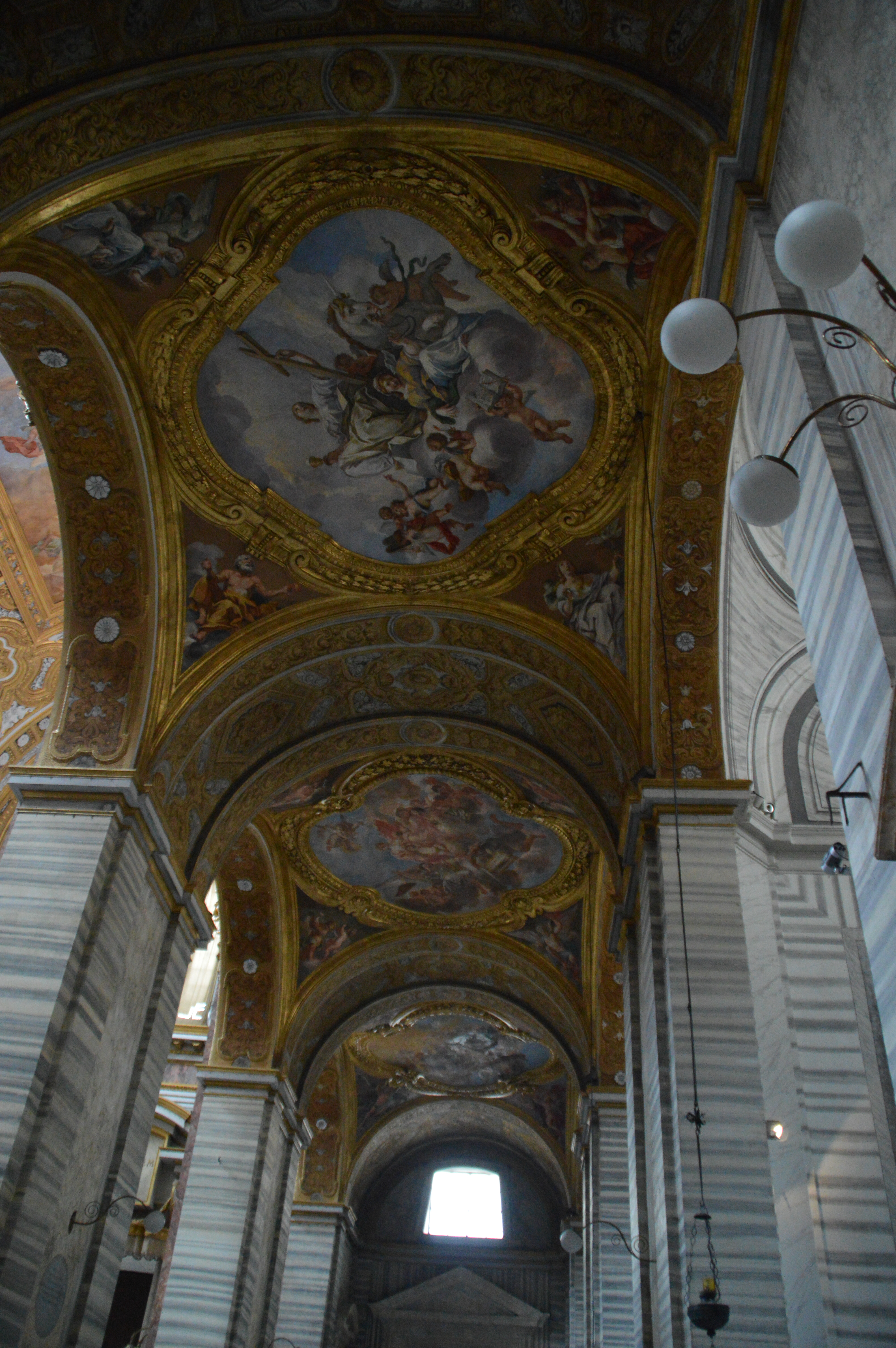 white statue of a robed figure holding a lantern