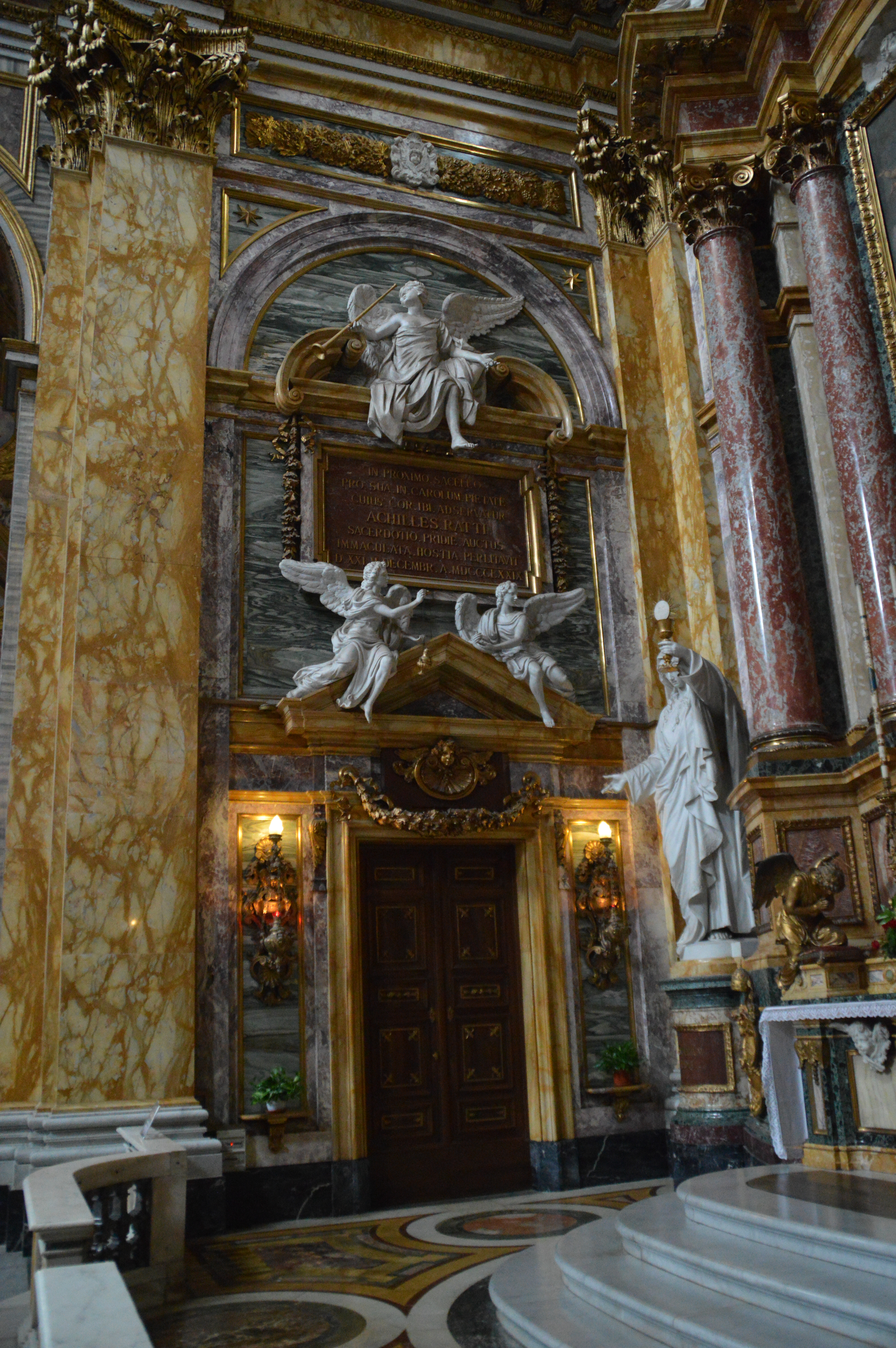 entrance is framed by marble columns with intricate gold and marble detailing