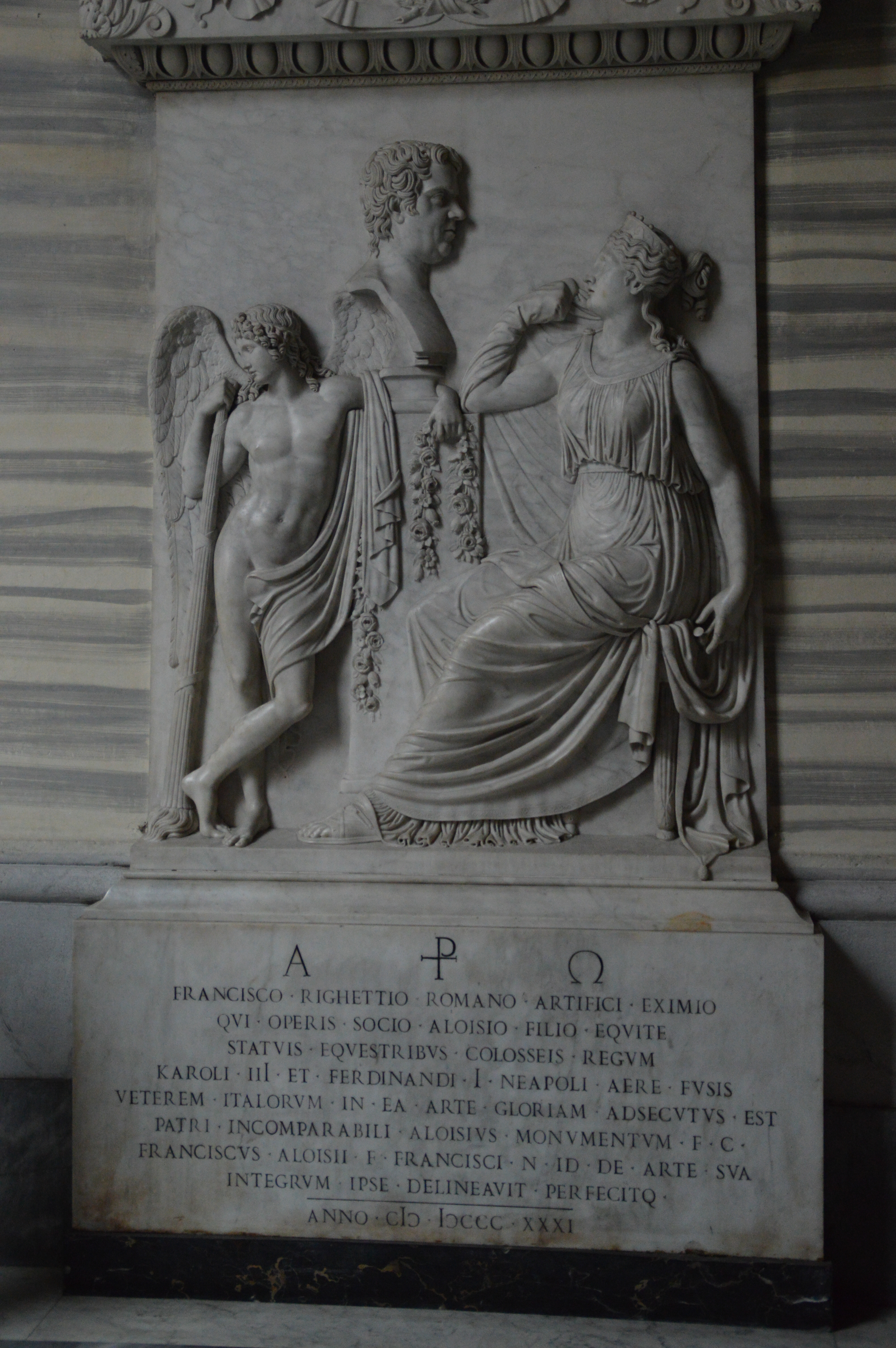 marble sculpture with three figures: a man, a woman, and an angel