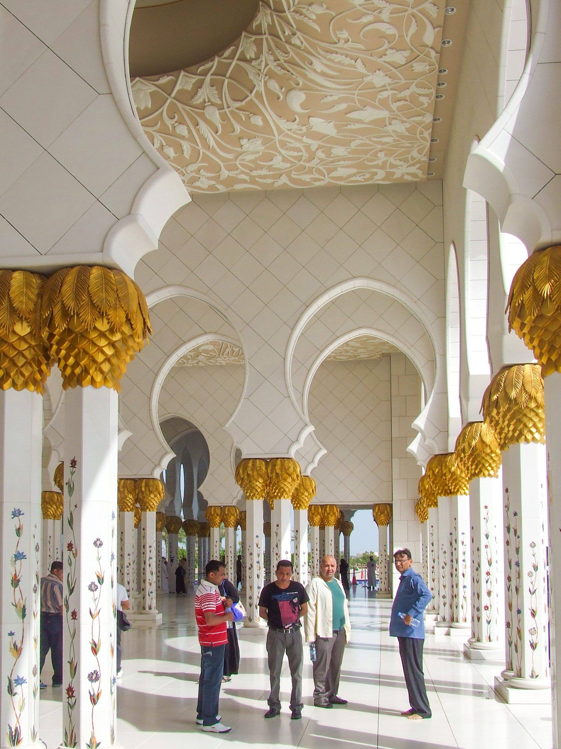 intricate white and gold designs on the ceiling and columns